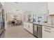 Open kitchen with stainless steel appliances, white cabinets, and view to the dining area at 4750 Tortona Ct, Bradenton, FL 34211