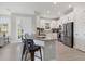 Bright kitchen featuring a center island with bar seating, white cabinets and stainless steel appliances at 4750 Tortona Ct, Bradenton, FL 34211