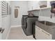 Functional laundry room featuring a modern washer and dryer with a utility sink and ample counter space at 4750 Tortona Ct, Bradenton, FL 34211