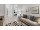 Living room with contemporary sofa and decor; view into a neutral toned bedroom and bath at 4750 Tortona Ct, Bradenton, FL 34211