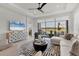 Bright living room featuring a large sliding glass door offering scenic views of the outdoor patio and lake at 4750 Tortona Ct, Bradenton, FL 34211