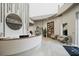 Elegant spa lobby with a curved reception desk, a reading nook, and neutral colors at 4750 Tortona Ct, Bradenton, FL 34211