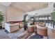 Luxurious lounge featuring couches, chairs, an electric fireplace, and greenery at 4750 Tortona Ct, Bradenton, FL 34211