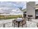 Charming outdoor patio with dining tables, lounge seating, and views of the lush landscaping and golf course at 4750 Tortona Ct, Bradenton, FL 34211