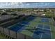 Aerial view of pickleball courts and tennis courts offering abundant outdoor recreational opportunities at 4750 Tortona Ct, Bradenton, FL 34211