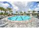 Spacious outdoor pool with lap lanes, lounge chairs, and mature palm trees at 4750 Tortona Ct, Bradenton, FL 34211