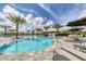 Relaxing outdoor pool area with lounge chairs, umbrellas, and lush landscaping at 4750 Tortona Ct, Bradenton, FL 34211