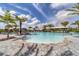 Inviting outdoor pool with a nearby bar, surrounded by lounge chairs and palm trees at 4750 Tortona Ct, Bradenton, FL 34211