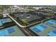 Aerial view of multiple tennis and pickleball courts surrounded by landscaping, providing abundant recreational opportunities at 4750 Tortona Ct, Bradenton, FL 34211