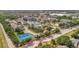 Beautiful aerial view of the community featuring lush landscaping, tennis courts, and a tranquil pond at 4802 51St W St # 107, Bradenton, FL 34210