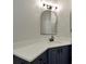 Bathroom featuring a quartz countertop, blue cabinets, and a vanity mirror at 4802 51St W St # 107, Bradenton, FL 34210