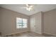 Bright bedroom featuring a ceiling fan, light wood flooring, and a large window offering natural light at 4802 51St W St # 107, Bradenton, FL 34210