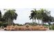 Scenic entrance with palm trees and landscape views to a stunning property at 4802 51St W St # 107, Bradenton, FL 34210