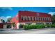 Exterior of Motorworks Brewing, featuring its distinctive red facade, signage and sidewalk seating at 4802 51St W St # 107, Bradenton, FL 34210