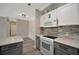 Open kitchen with modern appliances, stone countertops and access to the dining area at 4802 51St W St # 107, Bradenton, FL 34210