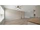 Open living area featuring wood-look floors, neutral paint, and a ceiling fan at 4802 51St W St # 107, Bradenton, FL 34210