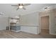 Bright living room featuring wood-look floors, a ceiling fan, and built in cabinets for storage at 4802 51St W St # 107, Bradenton, FL 34210
