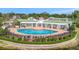 Stunning community pool with ample seating, manicured landscaping, and a pergola covered lounge area at 4802 51St W St # 107, Bradenton, FL 34210