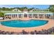 Inviting community pool featuring an expansive deck area with ample seating and shade at 4802 51St W St # 107, Bradenton, FL 34210
