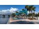 Scenic waterfront view with seating, palm trees, and a bridge offers a serene spot for relaxation at 4802 51St W St # 107, Bradenton, FL 34210