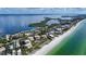 Breathtaking aerial view of the coastline featuring white sandy beaches, turquoise waters, and lush landscaping at 4968 Gulf Of Mexico Dr # Villa 22, Longboat Key, FL 34228