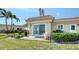 Private backyard featuring lush landscaping, a patio, and an exterior view of the home at 4968 Gulf Of Mexico Dr # Villa 22, Longboat Key, FL 34228