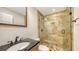 Bathroom featuring a glass shower with a modern tile surround, and vanity at 4968 Gulf Of Mexico Dr # Villa 22, Longboat Key, FL 34228