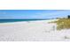 Expansive beach with white sand, calm turquoise water, and light surf offers relaxation and recreation at 4968 Gulf Of Mexico Dr # Villa 22, Longboat Key, FL 34228