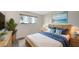 Cozy bedroom showcasing wicker furniture, tropical decor, and a comfortable bed with blue accents at 4968 Gulf Of Mexico Dr # Villa 22, Longboat Key, FL 34228