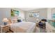 Bright bedroom featuring a comfortable bed, sitting area, and calming decor at 4968 Gulf Of Mexico Dr # Villa 22, Longboat Key, FL 34228