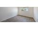 This bedroom features stylish tile floors and a window with neighborhood views at 4968 Gulf Of Mexico Dr # Villa 22, Longboat Key, FL 34228
