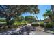 Beautifully landscaped common area with bike rack, guest parking, and walkway to community pool at 4968 Gulf Of Mexico Dr # Villa 22, Longboat Key, FL 34228