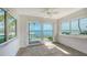 Serene dining space featuring tile floors, a ceiling fan, and sliding doors to a waterfront view at 4968 Gulf Of Mexico Dr # Villa 22, Longboat Key, FL 34228