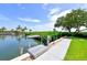 Private boat dock features a lift with direct water access and serene waterfront views at 4968 Gulf Of Mexico Dr # Villa 22, Longboat Key, FL 34228