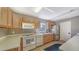 Functional kitchen with stainless steel appliances, ample counter space, and wood cabinets at 4968 Gulf Of Mexico Dr # Villa 22, Longboat Key, FL 34228