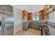 Kitchen showcases granite countertops, stainless steel appliances, and custom wood and green cabinetry at 4968 Gulf Of Mexico Dr # Villa 22, Longboat Key, FL 34228