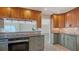 Updated kitchen with sleek cabinets, granite counters, stainless appliances, and a view to the water at 4968 Gulf Of Mexico Dr # Villa 22, Longboat Key, FL 34228