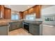 Updated kitchen with granite counters, tiled backsplash, stainless appliances, and sleek cabinetry at 4968 Gulf Of Mexico Dr # Villa 22, Longboat Key, FL 34228
