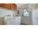 Bright laundry room with washer, dryer, and outdoor access, with nice views at 4968 Gulf Of Mexico Dr # Villa 22, Longboat Key, FL 34228