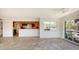 Bright living room with tile flooring, open to the kitchen, leading out to a patio and waterfront view at 4968 Gulf Of Mexico Dr # Villa 22, Longboat Key, FL 34228
