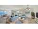 Bright living room with views of the Gulf of Mexico, stylish furnishings, and tile flooring at 4968 Gulf Of Mexico Dr # Villa 22, Longboat Key, FL 34228