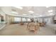 Spacious meeting room with multiple tables, chairs, and large windows providing plenty of natural light at 4968 Gulf Of Mexico Dr # Villa 22, Longboat Key, FL 34228