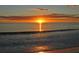 Breathtaking sunset over the ocean, casting a warm glow on the water and sandy shore at 4968 Gulf Of Mexico Dr # Villa 22, Longboat Key, FL 34228