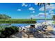 Relax outdoors by the water in this peaceful community lounge with comfortable Adirondack chairs at 4968 Gulf Of Mexico Dr # Villa 22, Longboat Key, FL 34228