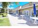 Outdoor patio area features tables, chairs, and umbrellas, perfect for relaxing and enjoying the weather at 4968 Gulf Of Mexico Dr # Villa 22, Longboat Key, FL 34228