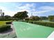 Enjoy outdoor recreation with the shuffleboard court and lush landscaping, surrounded by mature trees and manicured hedges at 4968 Gulf Of Mexico Dr # Villa 22, Longboat Key, FL 34228