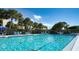 Bright and inviting swimming pool with lounge chairs, surrounded by tropical foliage at 4968 Gulf Of Mexico Dr # Villa 22, Longboat Key, FL 34228
