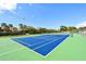 Well-maintained tennis court with a clear view of the surrounding landscape and sky at 4968 Gulf Of Mexico Dr # Villa 22, Longboat Key, FL 34228
