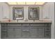 Bathroom featuring double vanity with stone countertop, cabinets and framed mirrors at 5282 Box Turtle Cir, Sarasota, FL 34232