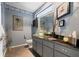Stylish bathroom featuring blue walls, a glass vessel sink, and unique decorative accents and artwork at 5282 Box Turtle Cir, Sarasota, FL 34232